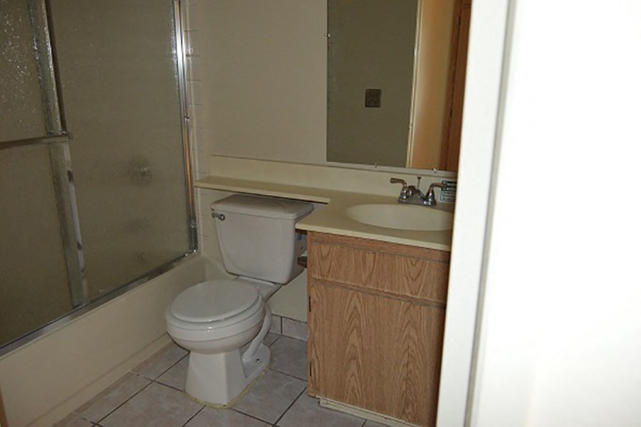 a bathroom with a toilet and a sink and a shower