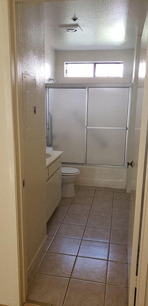 a bathroom with a toilet and a sink and a shower