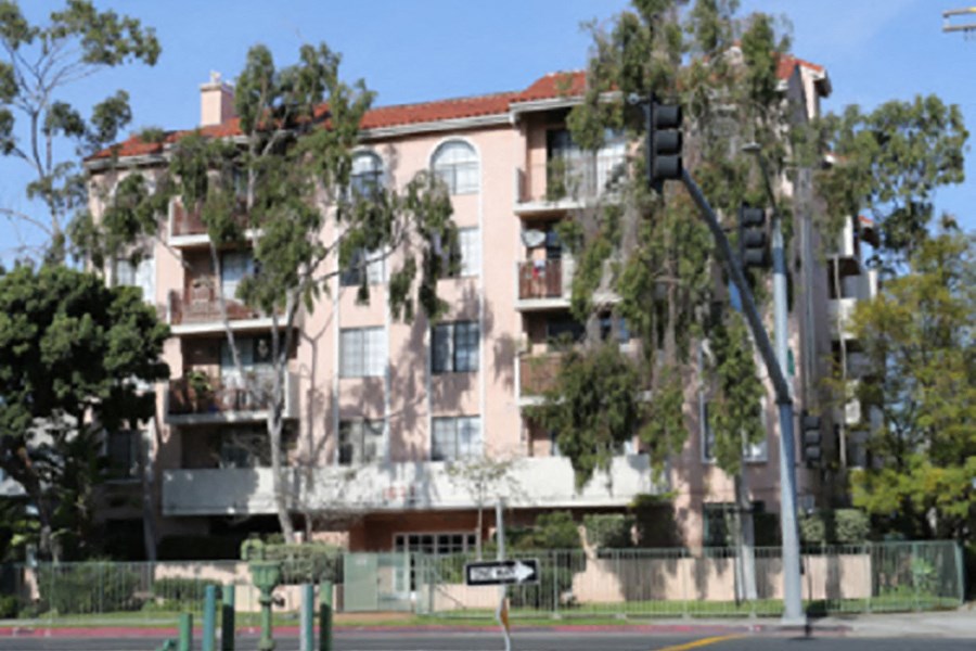an apartment building with a traffic light in front of it