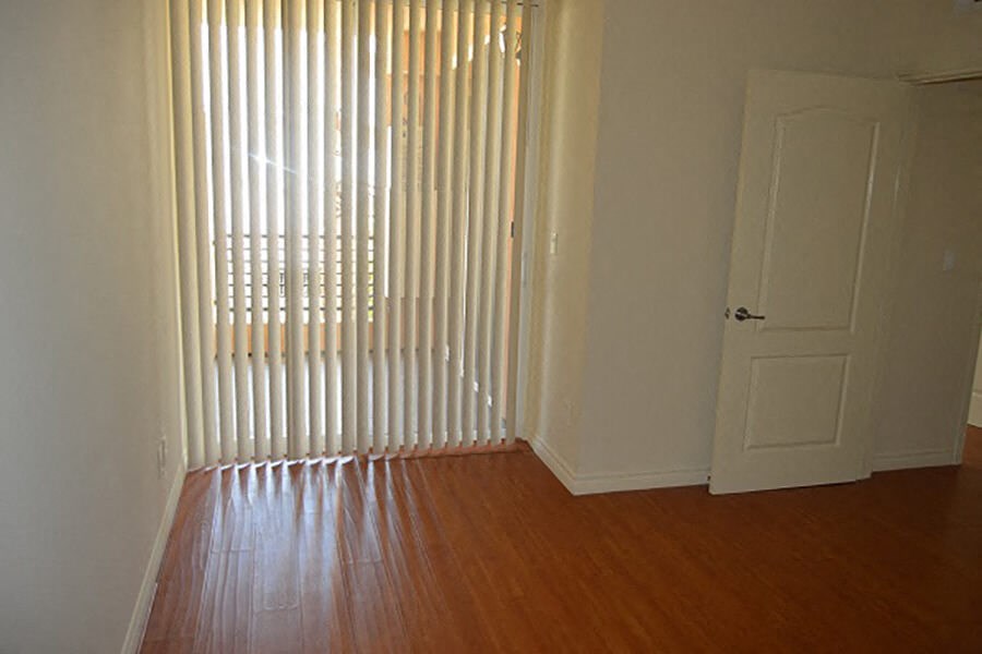 a room with a wooden floor and a white door
