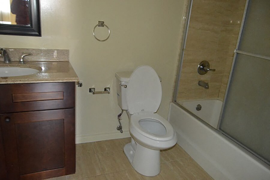 a bathroom with a toilet and a sink and a shower
