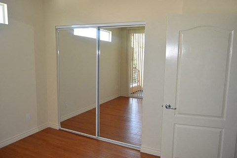 an empty room with a mirror and a door