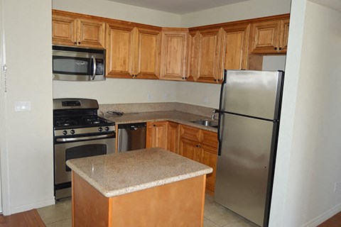 a kitchen with stainless steel appliances and wooden cabinets