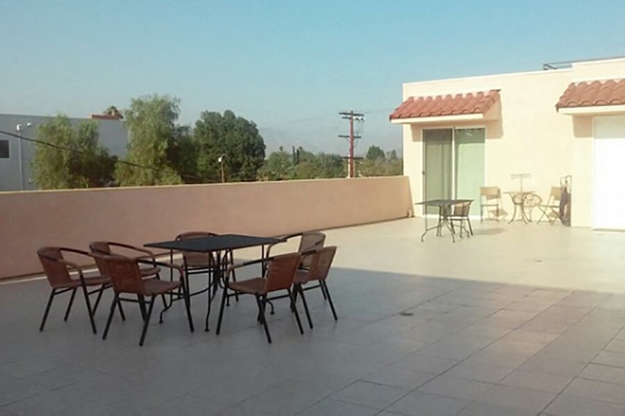 a patio with a table and chairs on a roof
