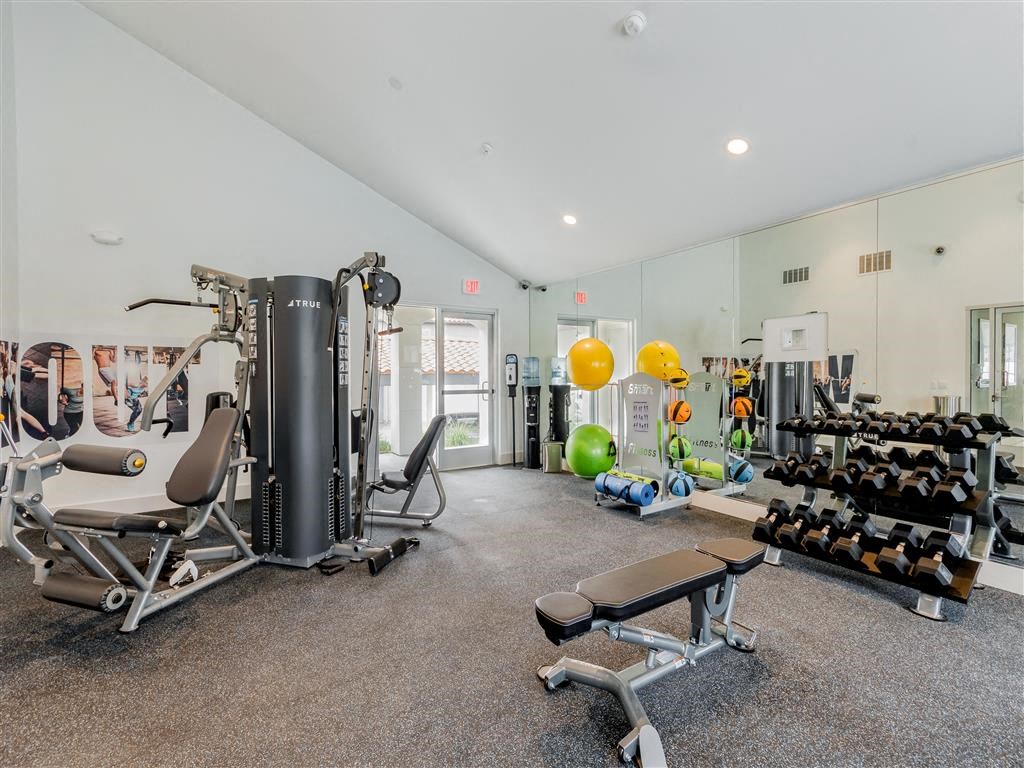 a workout room with weights and cardio equipment at the preserve at great pond apartments in windsor  at Laguna Gardens Apts., Laguna Niguel, California