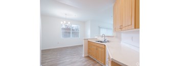 A kitchen with wooden cabinets and a white countertop.