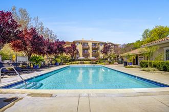 a swimming pool with trees and a building in the background a swimming pool with trees and a building in the background at Cornerstone at Gale Ranch, California, 94582