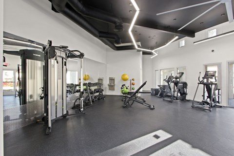 A gym with a variety of exercise equipment.