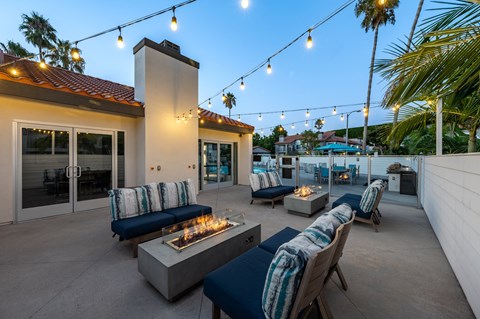a patio with couches and chairs and a fire pit  at Laguna Gardens Apts., Laguna Niguel, CA, 92677