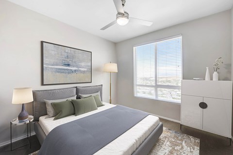 A bedroom with large window and a ceiling fan at The Overlook Santa Clarita, CA 91350