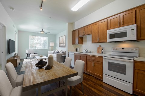 A kitchen with a wooden table and chairs.