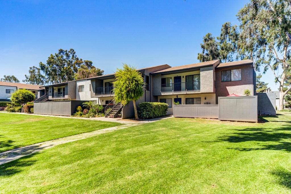 a house with a green lawn in front of it  at Redlands Park Apts, California
