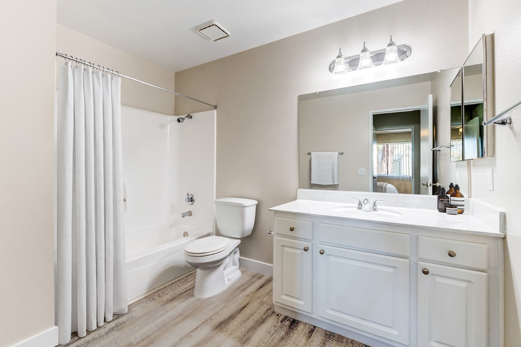 a bathroom with a shower toilet and sink at Redlands Park Apts, Redlands, CA, 92373
