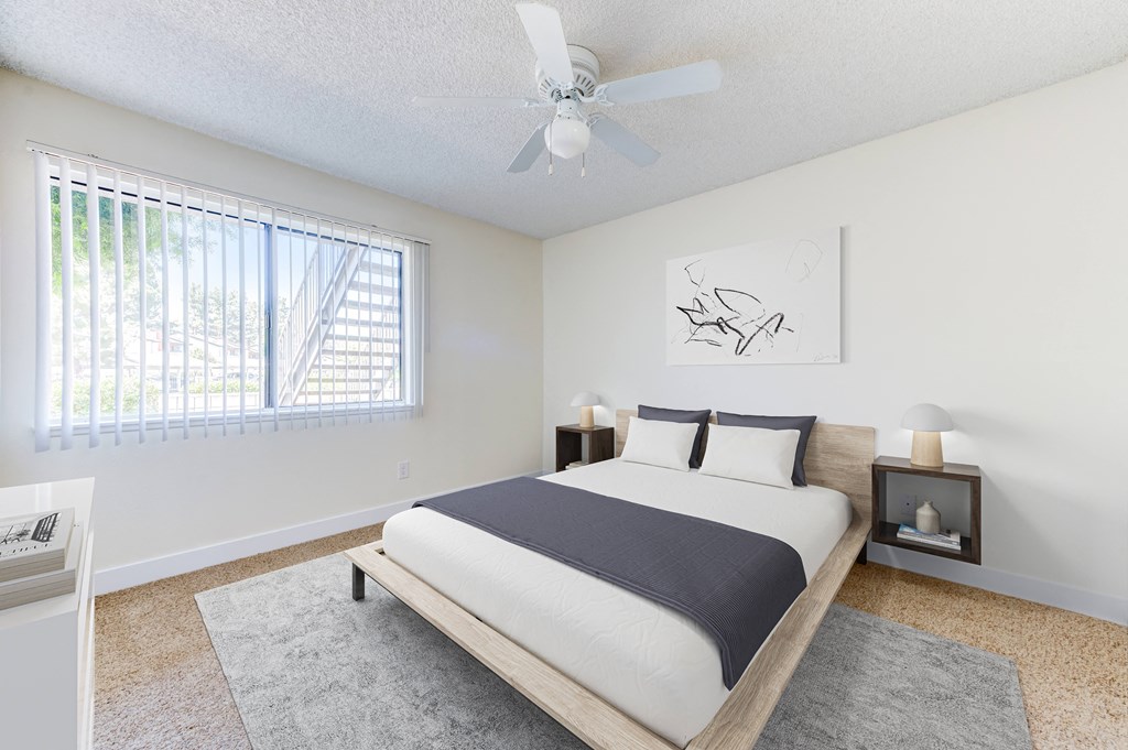 2 bed 1 bath floor plan a bedroom with a bed and a ceiling fan at Redlands Park Apts, California