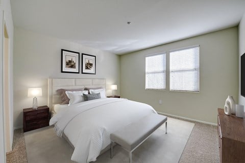 a bedroom with a large bed and two windows  at Sonoma at Porter Ranch, Porter Ranch, CA