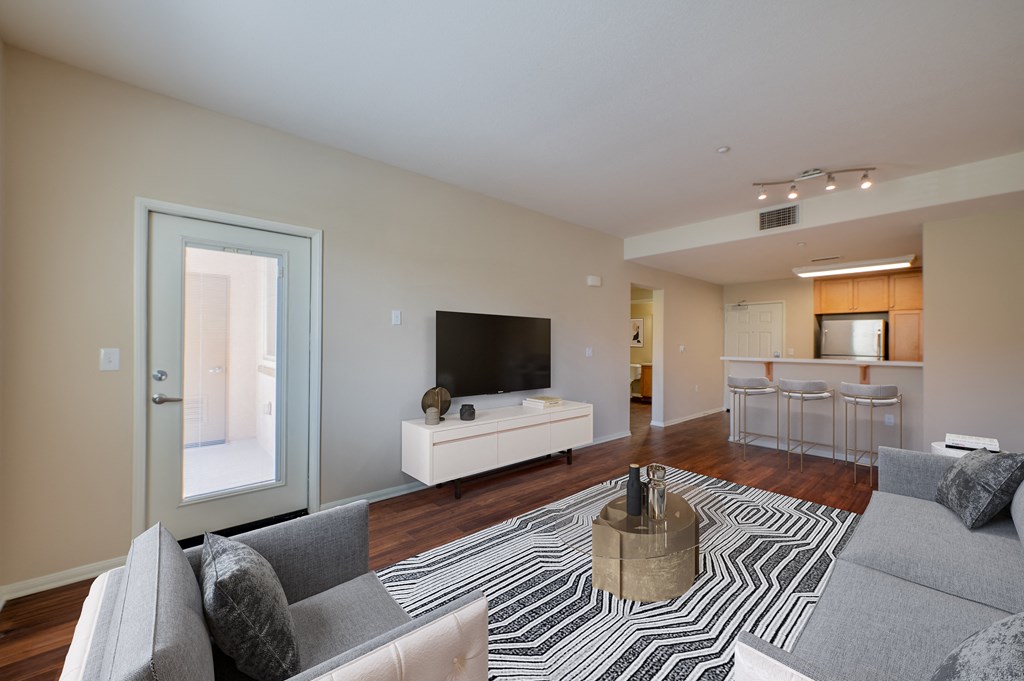 a living room with a couch and a chair  at Ventana Senior Apartments, California, 91326