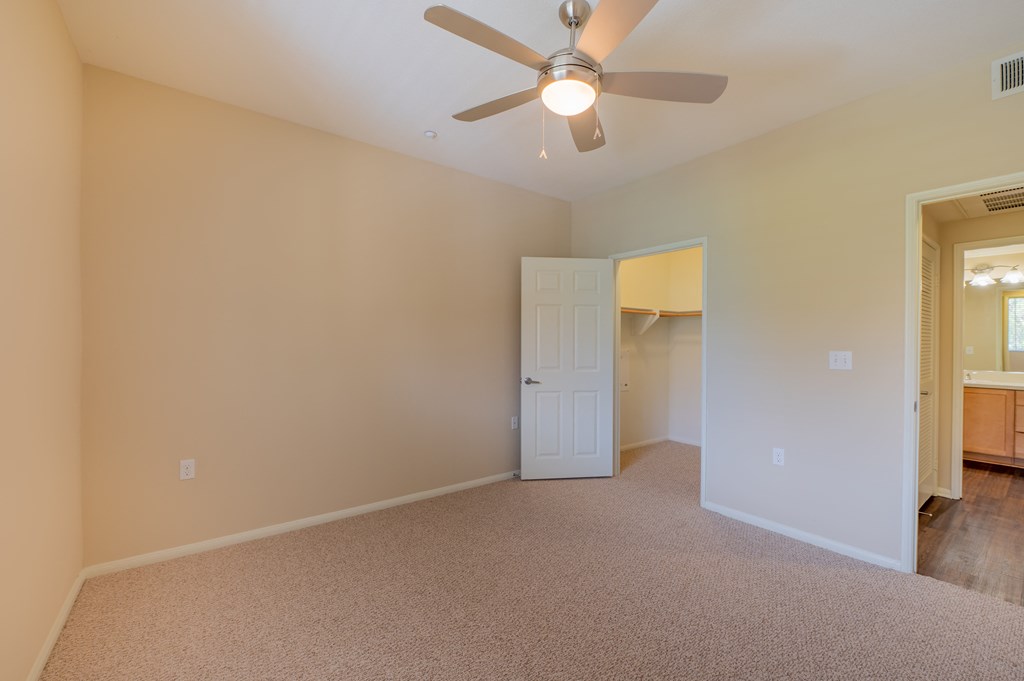 a bedroom with a ceiling fan  at Ventana Senior Apartments, California, 91326