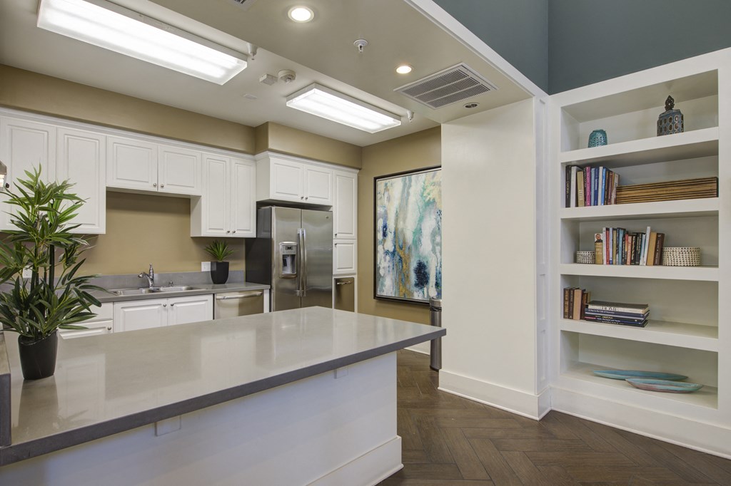 a kitchen with white cabinets and a large island  at Ventana Senior Apartments, Northridge