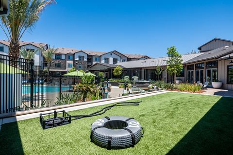 a backyard with a pool and a fire pit at The Vineyards Apartments, Porter Ranch, California