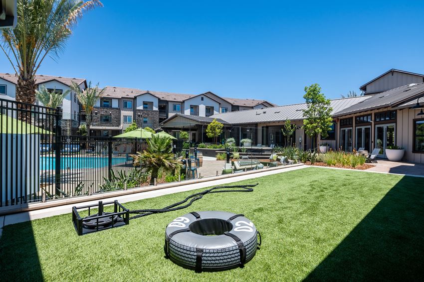 a backyard with a pool and a fire pit a backyard with a pool and a fire pit at The Vineyards Apartments, Porter Ranch, California