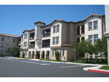a large apartment building with a street in front of it  at Monarch at Dos Vientos, Newbury Park, CA, 91320 - Photo Gallery 2