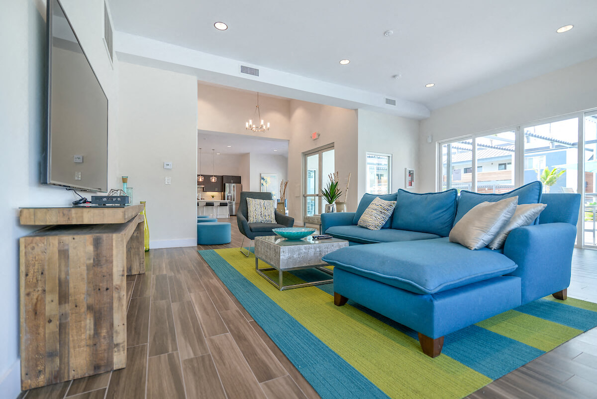 a living room with a blue couch and a tv