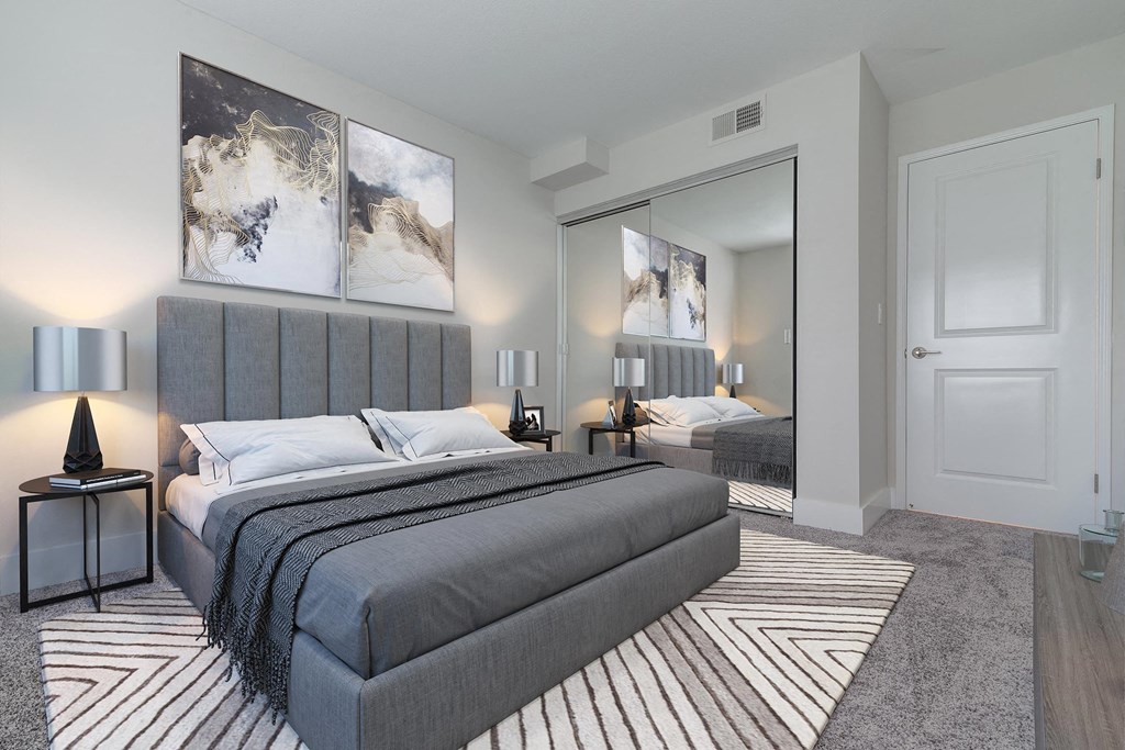 a bedroom with a bed and a mirror  at Laguna Gardens Apts., Laguna Niguel