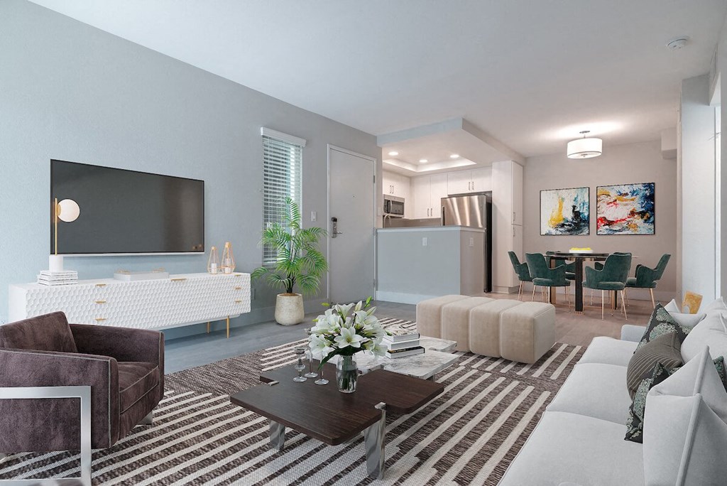 a living room with blue walls and a large tv on the wall  at Laguna Gardens Apts., California