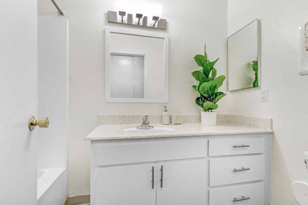 a bathroom with a sink and a mirror  at Sherway Villa, Reseda