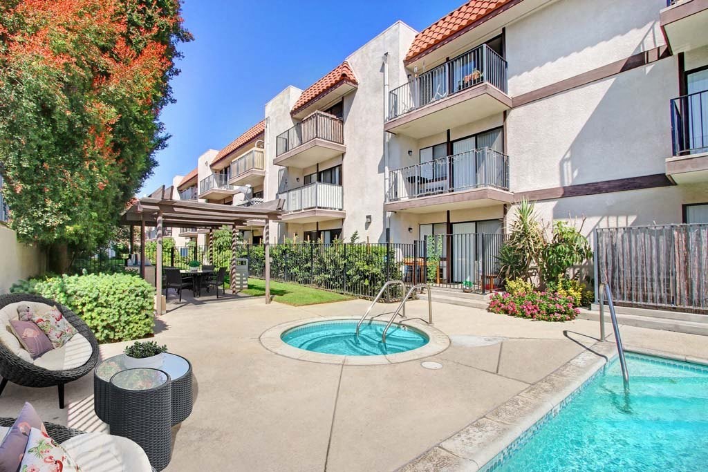 a swimming pool in front of an apartment building  at Sherway Villa, Reseda, CA