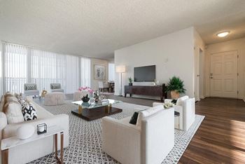 a living room filled with furniture and a flat screen tv at  Park Avenue Apartments, California,90815