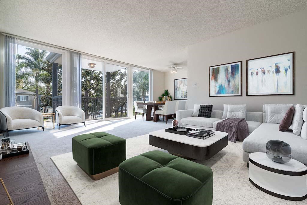 a living room filled with furniture and a large window at  Park Avenue Apartments, California