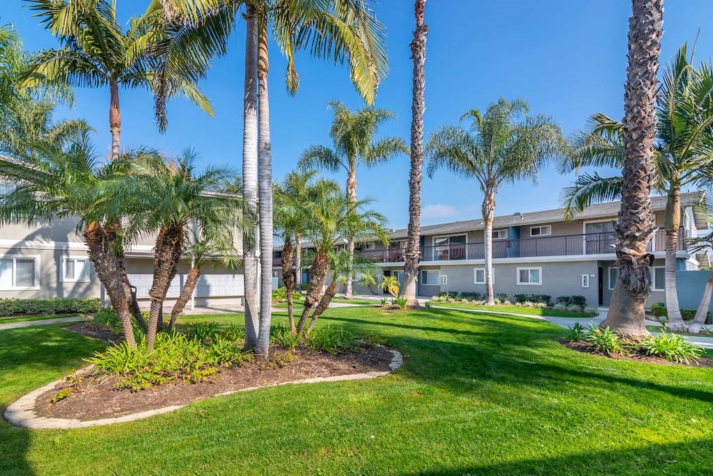 a building with palm trees in front of it at Park Avenue Apartments, Long Beach, CA, 90815