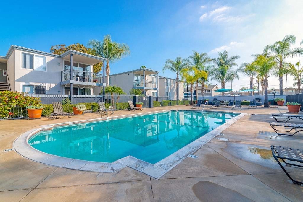 a swimming pool with a building in the background at Park Avenue Apartments, Long Beach, CA, 90815
