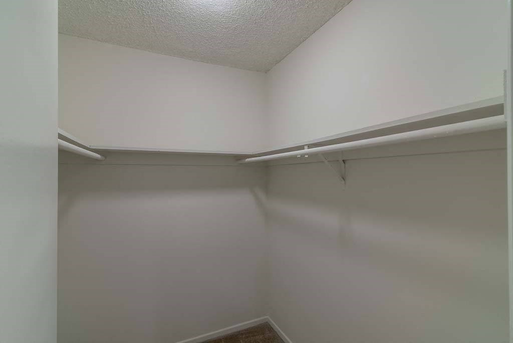 a walk in closet in a bedroom at  Park Avenue Apartments, California