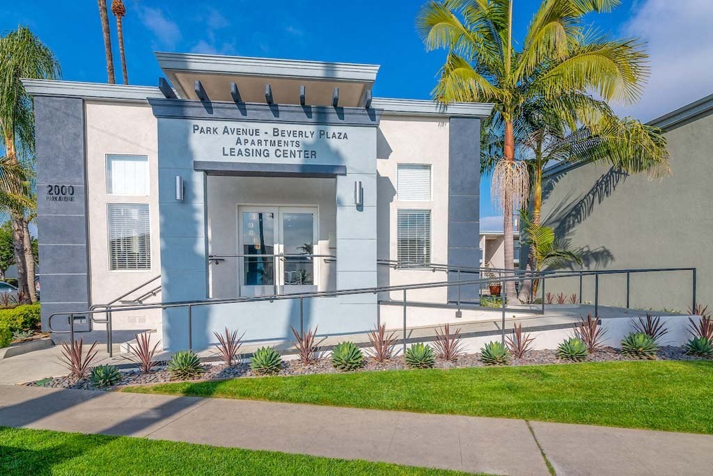 a building with a palm tree in front of it at  Park Avenue Apartments, Long Beach