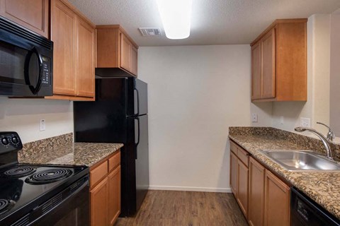 Kitchen with wooden cabinets at Meadow Wood at Alamo Creek, California