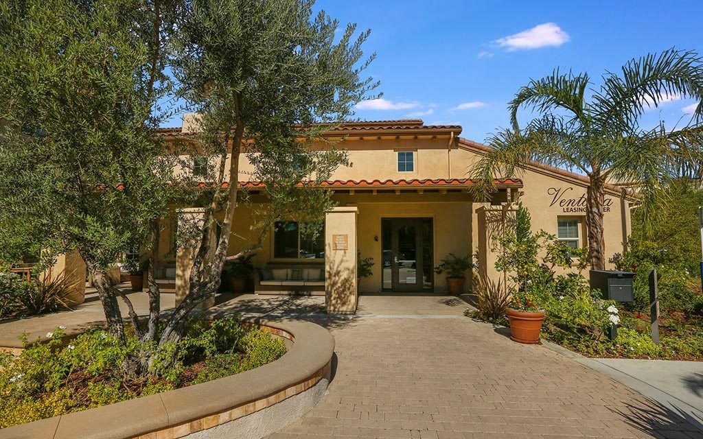 a building with a porch and trees in front of it at Ventana Senior Apartments, California, 91326