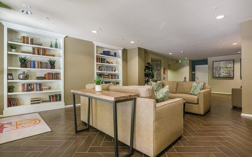a living room with couches and a table  at Ventana Senior Apartments, Northridge, 91326