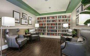 a living room filled with furniture and a book shelf  at Ventana Senior Apartments, Northridge, CA, 91326