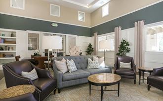 a living room with a couch chairs and tables at Ventana Senior Apartments, California, 91326 - Photo Gallery 5