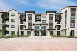 a large building with a blue sky in the background  at Deer Creek Apartments, San Ramon, CA, 94582