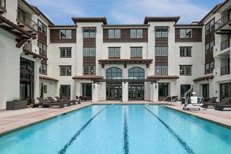 a swimming pool in front of a building  at Deer Creek Apartments, San Ramon, 94582