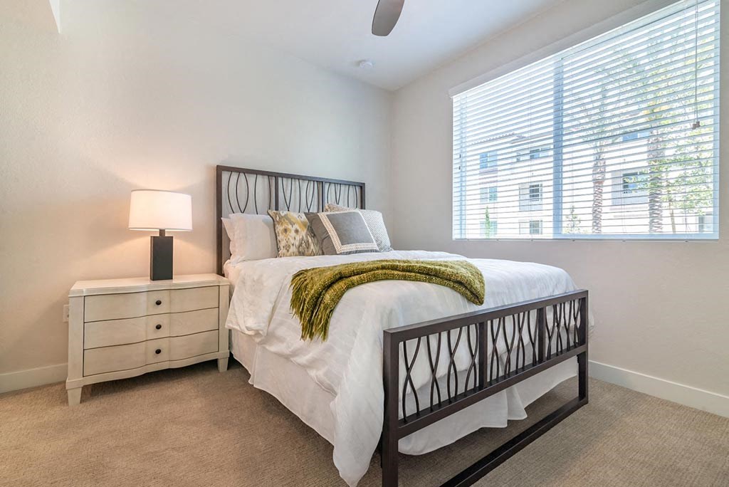 Bedroom with cozy bed  at Montecito Apartments at Carlsbad, California