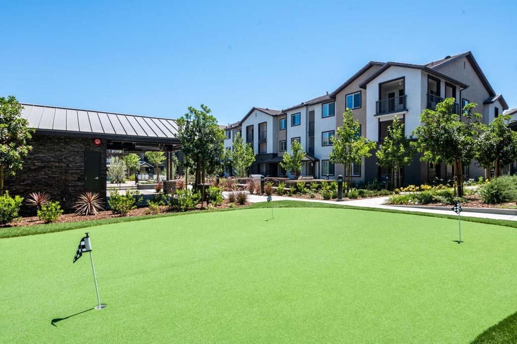 a putting green in front of a building  at The Vineyards Apartments, California, 91326