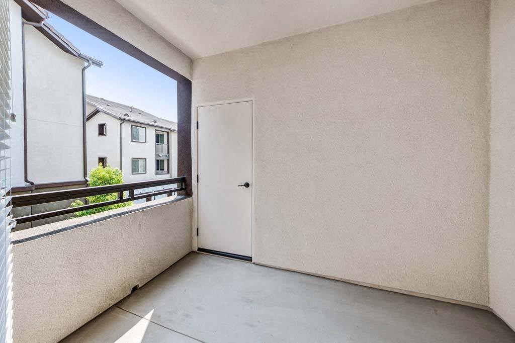 a room with a large window and a door at The Vineyards Apartments, Porter Ranch