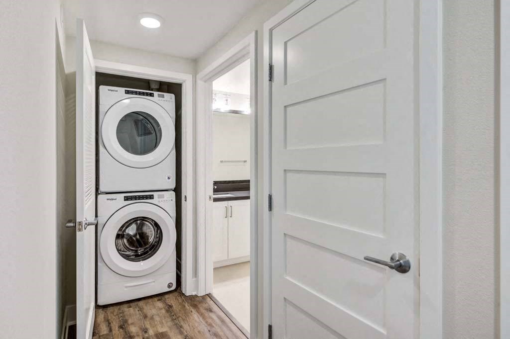 a small laundry room with a washer and dryer at The Vineyards Apartments, Porter Ranch, CA