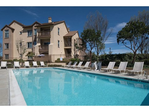 resort style swimming pool with lounge chairs at Seville at Gale Ranch, California