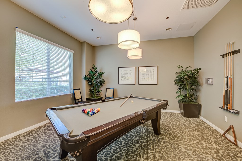 a resident clubhouse with a pool table  at Tesoro Senior Apartments, California, 91326