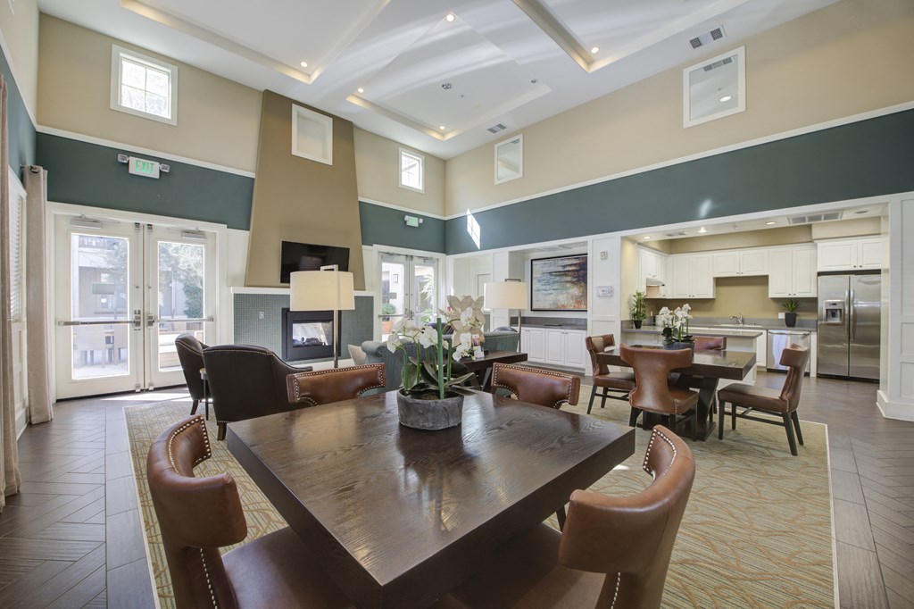 a resident clubhouse with a fireplace and dining table a resident clubhouse with a fireplace and dining table at Ventana Senior Apartments, California, 91326
